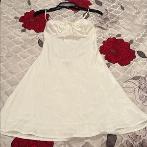 White, satin-finish, spaghetti strap slip dress.Floral embossed print